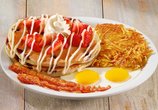 Denny's pancakes served with two eggs and golden hash browns