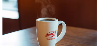 A coffee mug with the Denny's logo and the phrase "It's Diner Time" on the front