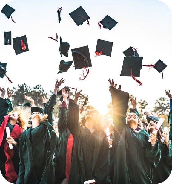 Graduates throwing their graduation hats in the air