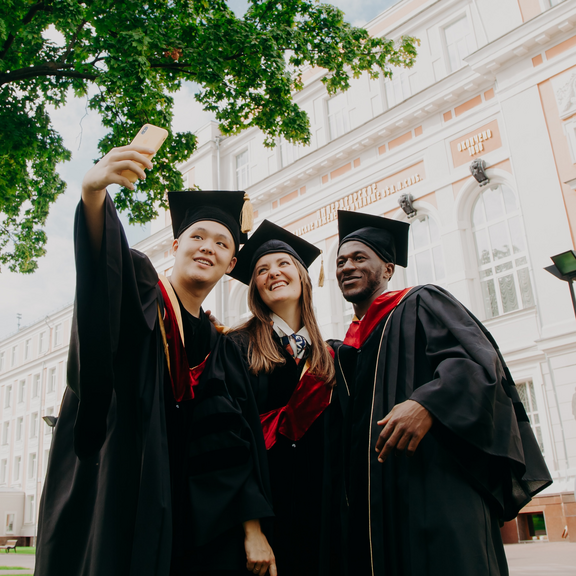 3 College Students in their Graduation robes